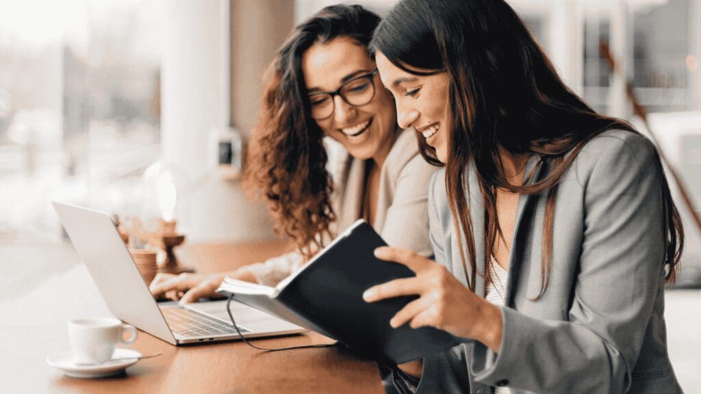 View of female entrepreneurs in a coaching session working together to identify business blind spots and plan for growth