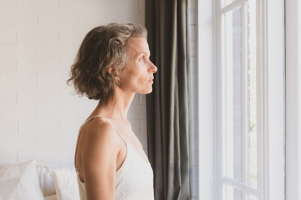 Female entrepreneur reflecting during burnout recovery.