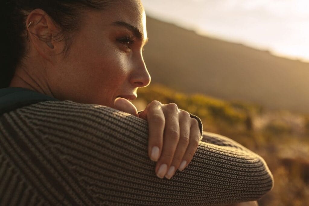 Woman reflecting on entrepreneur burnout recovery with calm confidence.