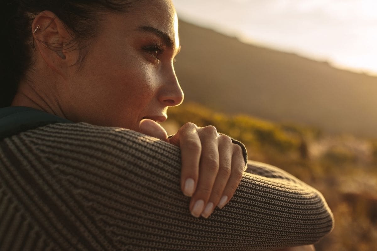 Woman reflecting on entrepreneur burnout recovery with calm confidence.