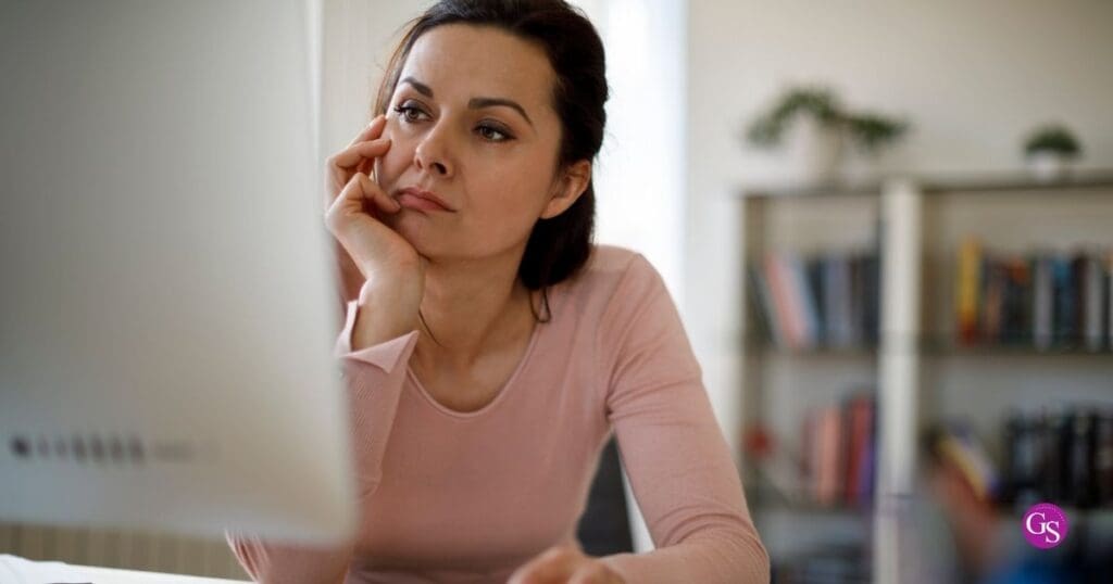 Network marketing leader at her desk looking thoughtful about why her team is not growing