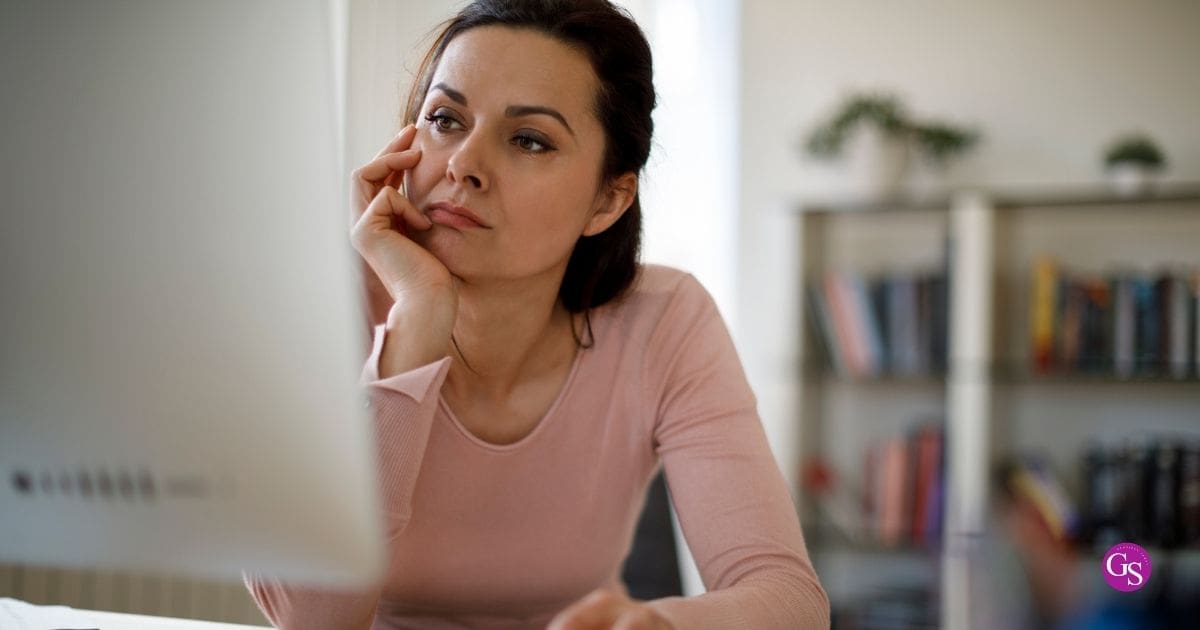 Network marketing leader at her desk looking thoughtful about why her team is not growing